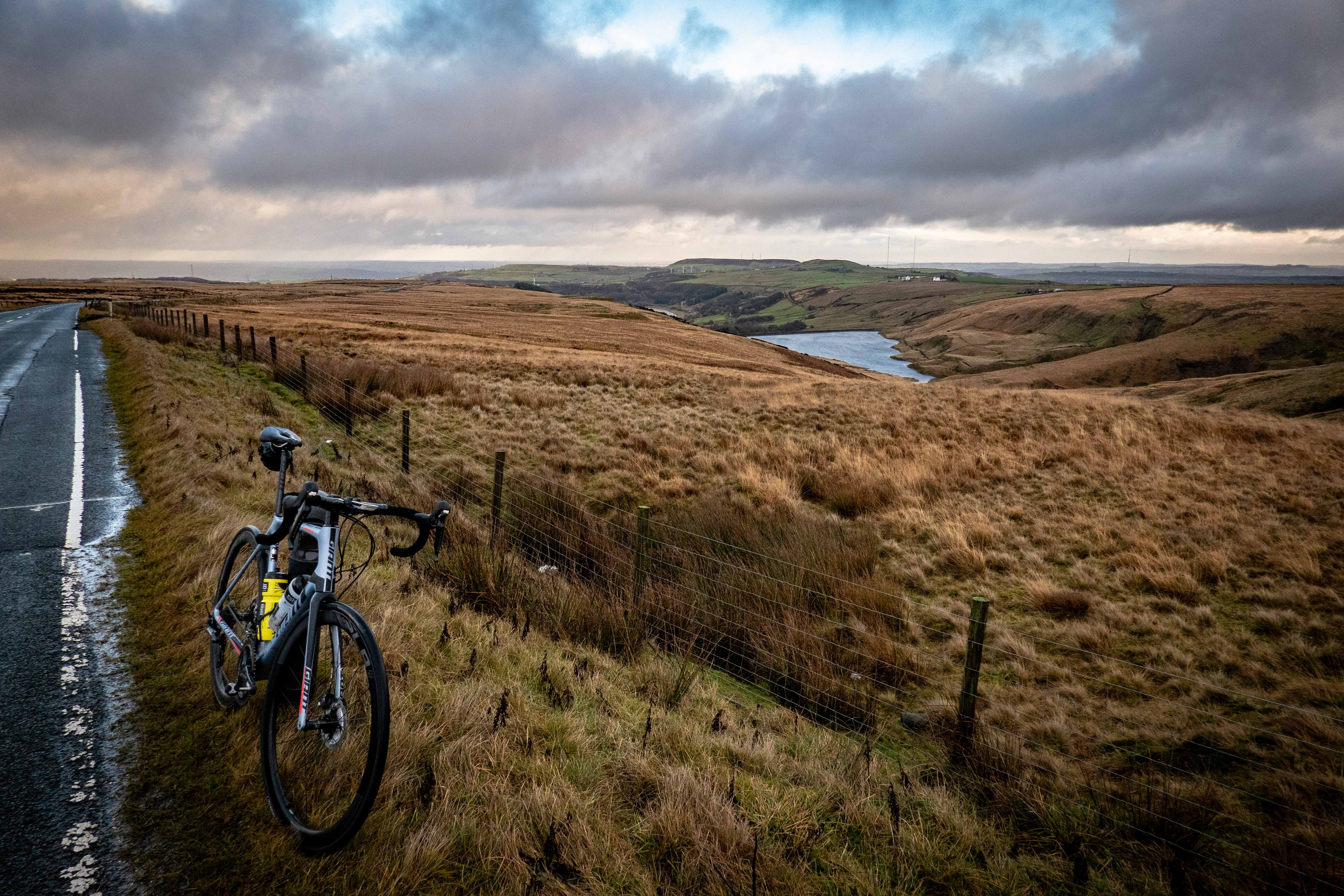 black and white road bike near brown field vehicle 2k 4k 5k