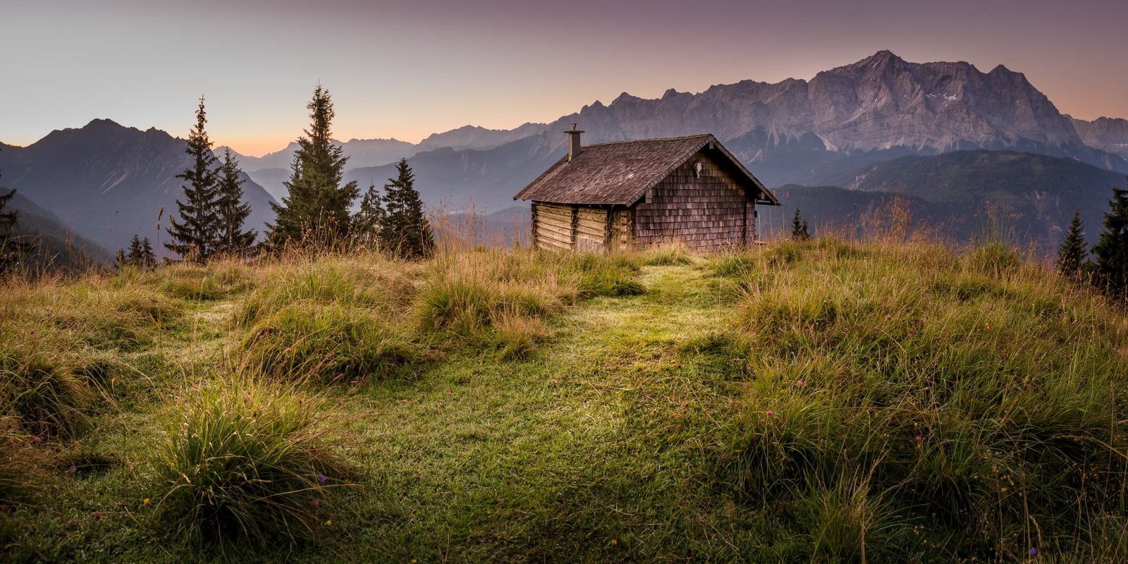 brown wooden house on top of mountain during golden hour Alm 2k 4k