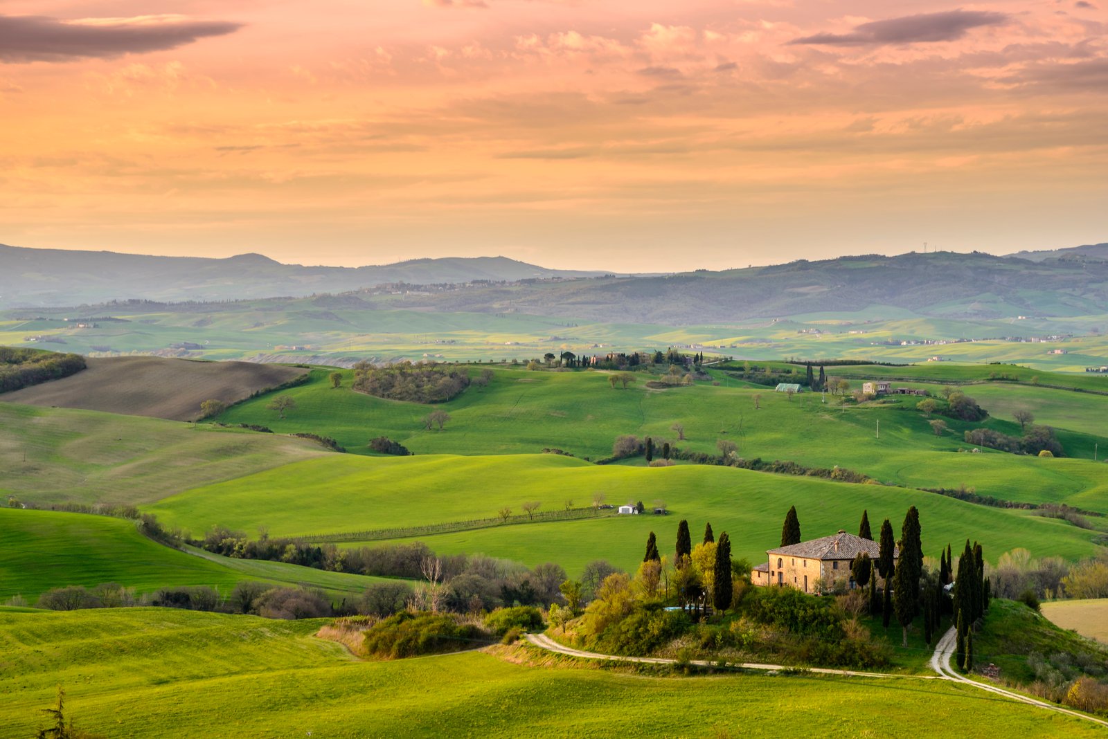 photo of yellow and brown concrete house surrounded with green trees field grasses val d orcia 2k 4k 5k