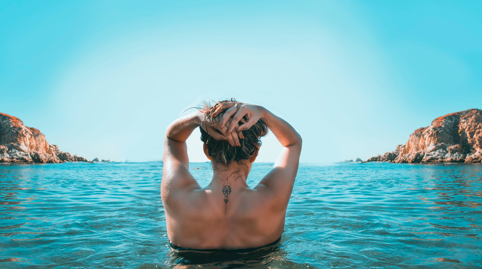 Woman on Holding Her Head While Standing Body of Water beach 2k 4k 5k 8k
