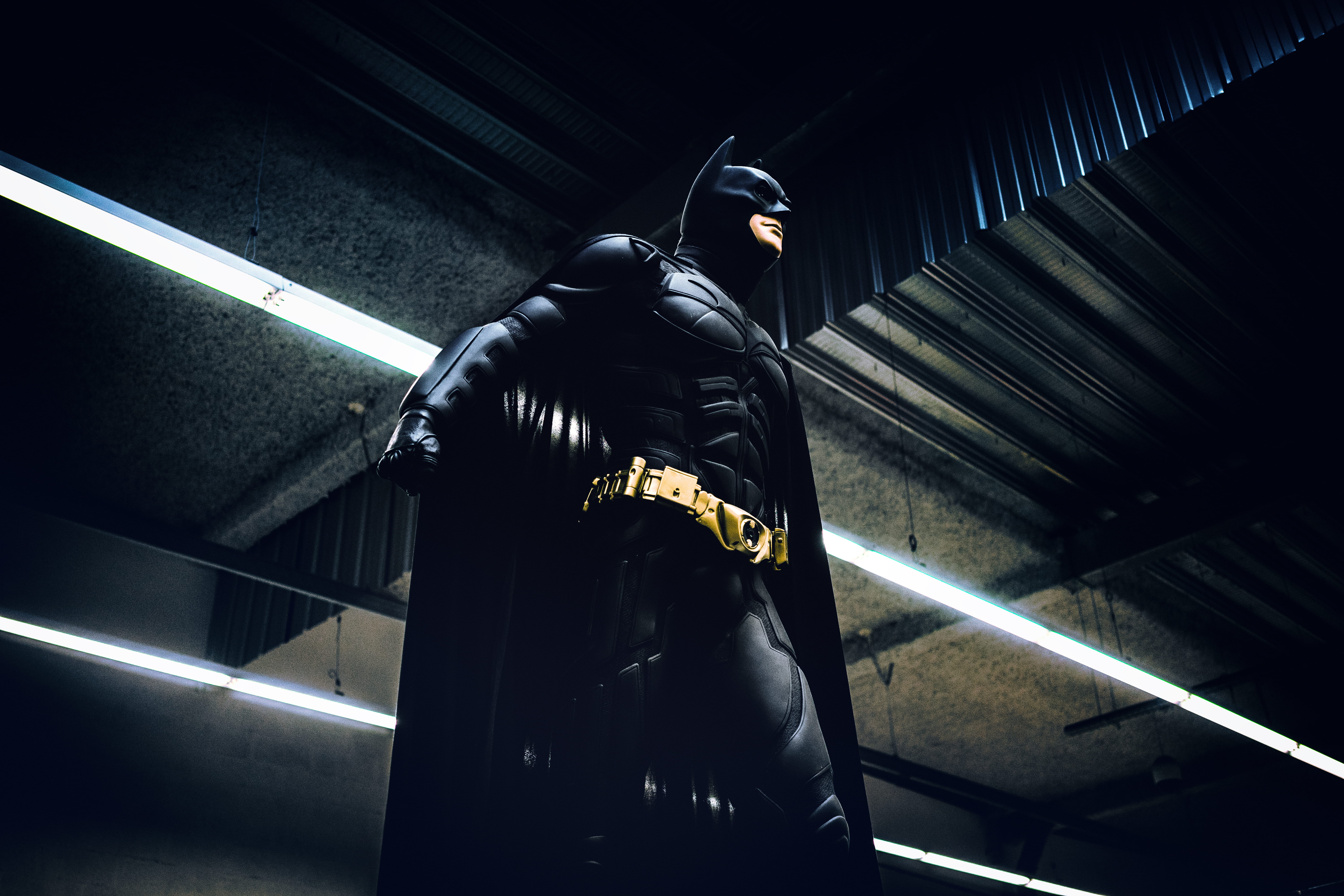 Batman standing under steel roof inside building 2k 4k 5k