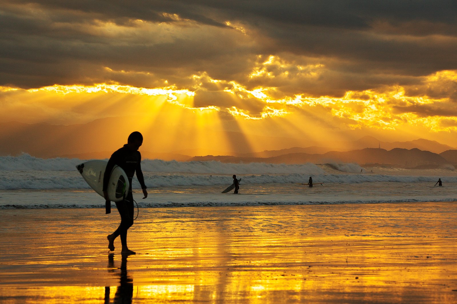 man carrying surfboard beside sea during sunset locals beach 2k 4k 5k