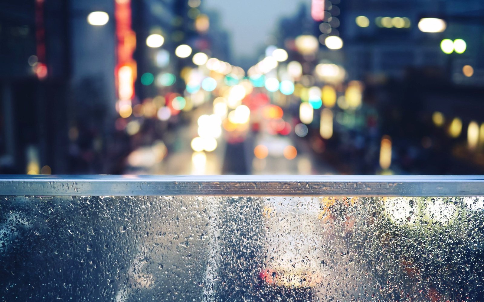 city bokeh photo shallow focus photography of gray steel handrail during nighttime 2k