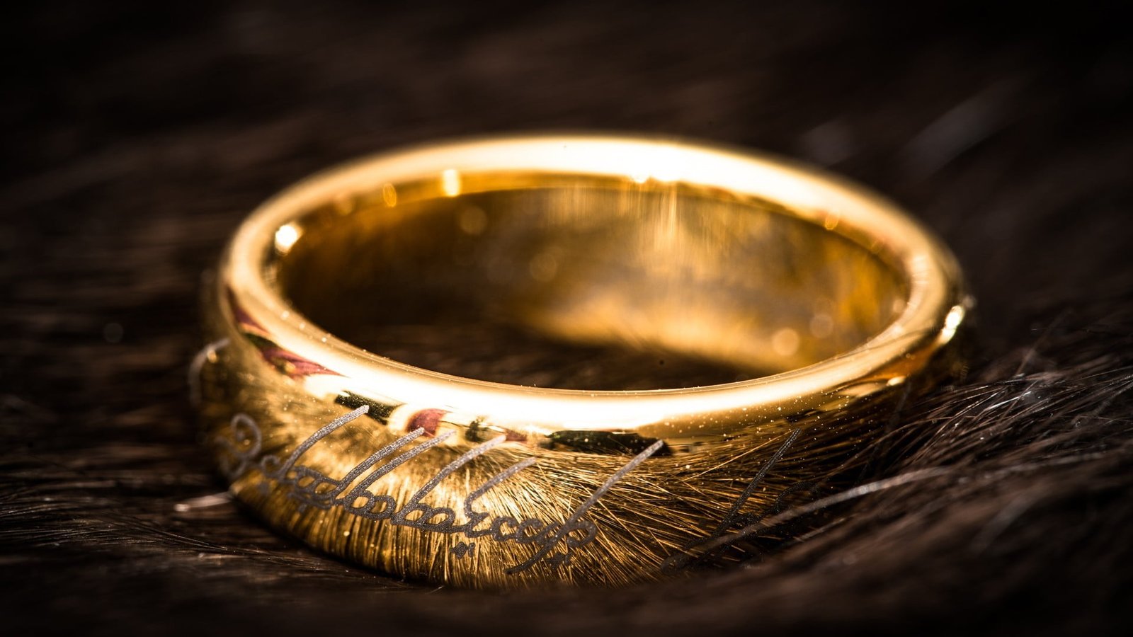 gold colored ring on brown wooden surface 2k