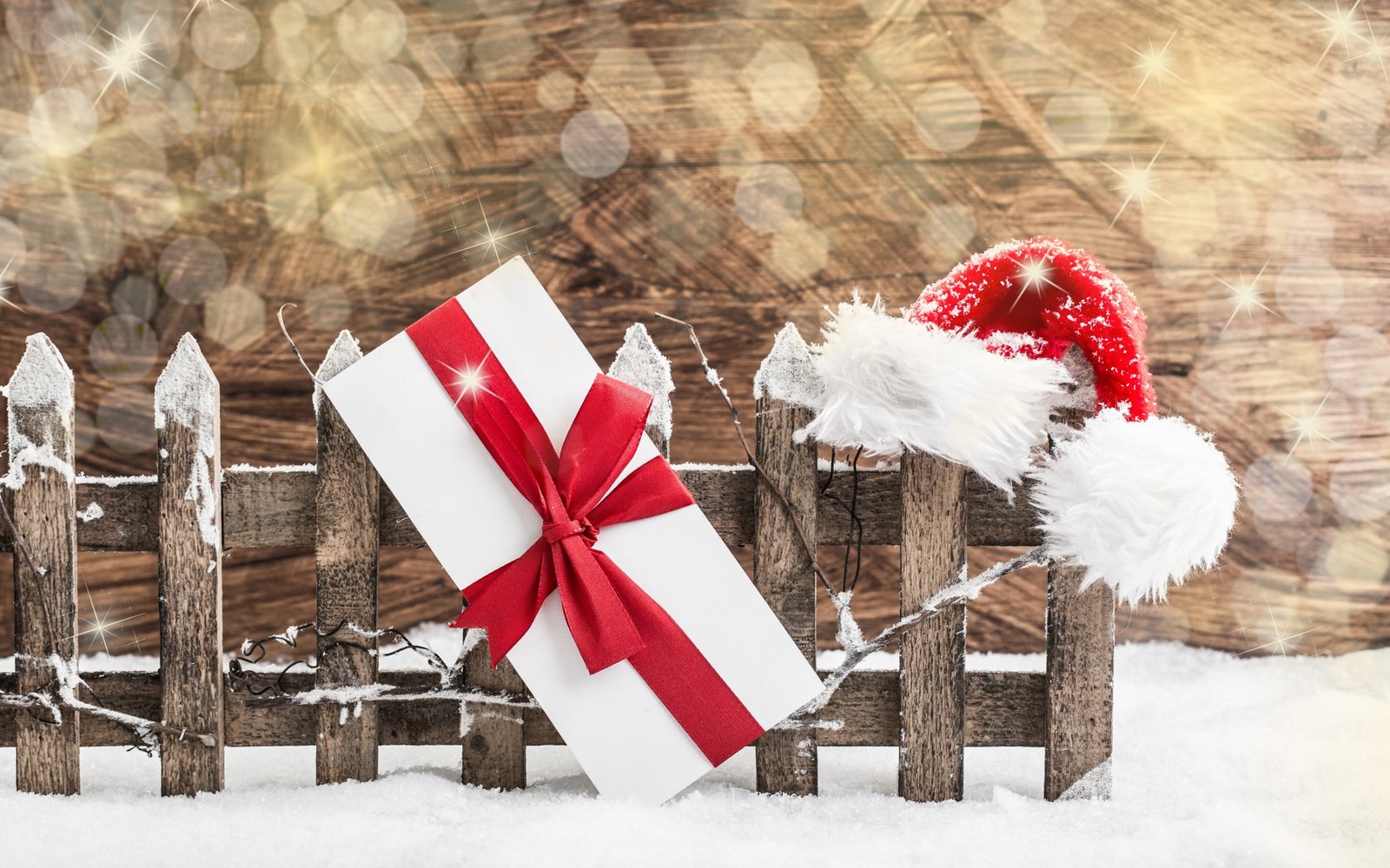 red and white gift box New Year snow fence presents Santa hats 2k
