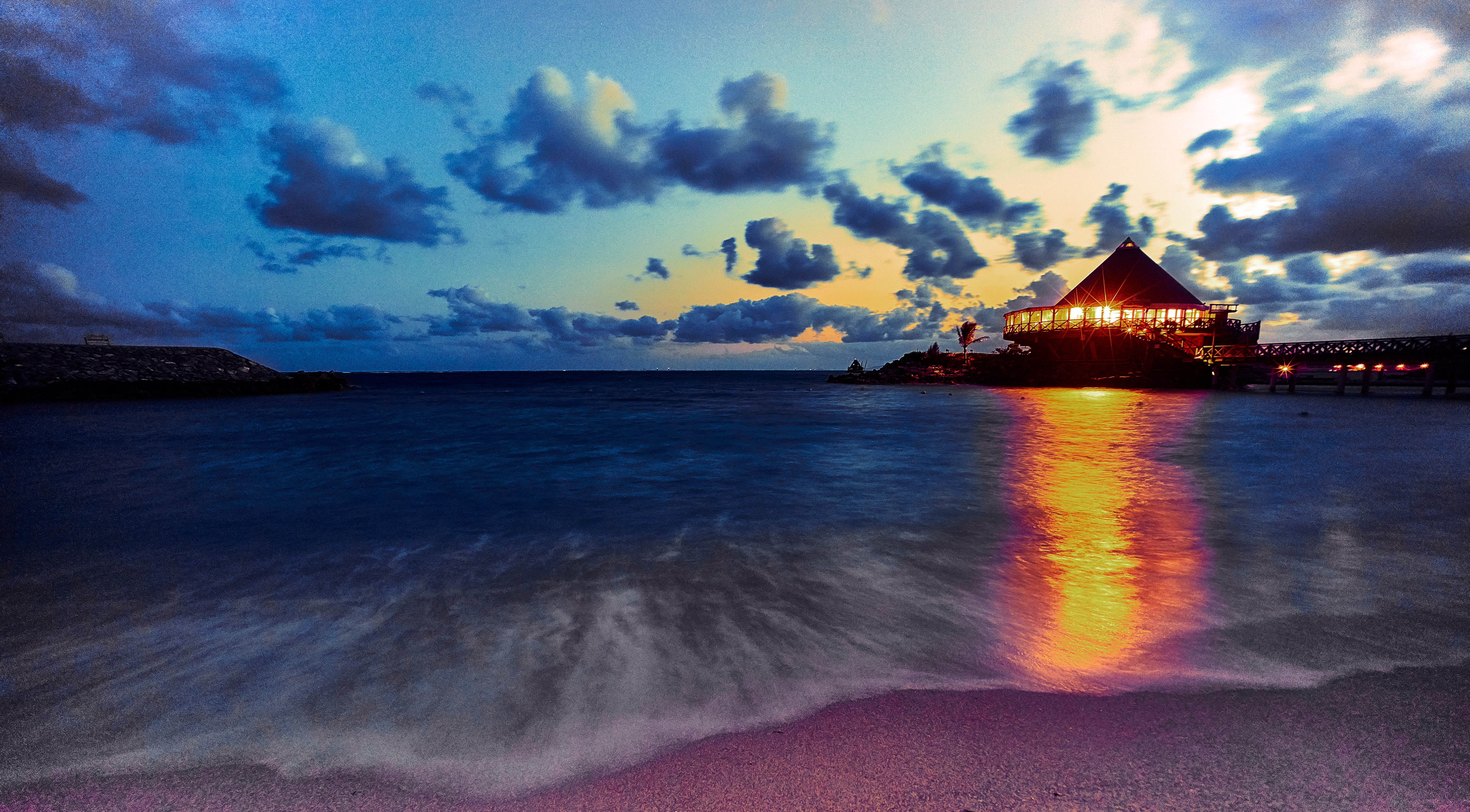 house beside sea shore against sunset rays under blue sky okinawa 2k 4k 5k