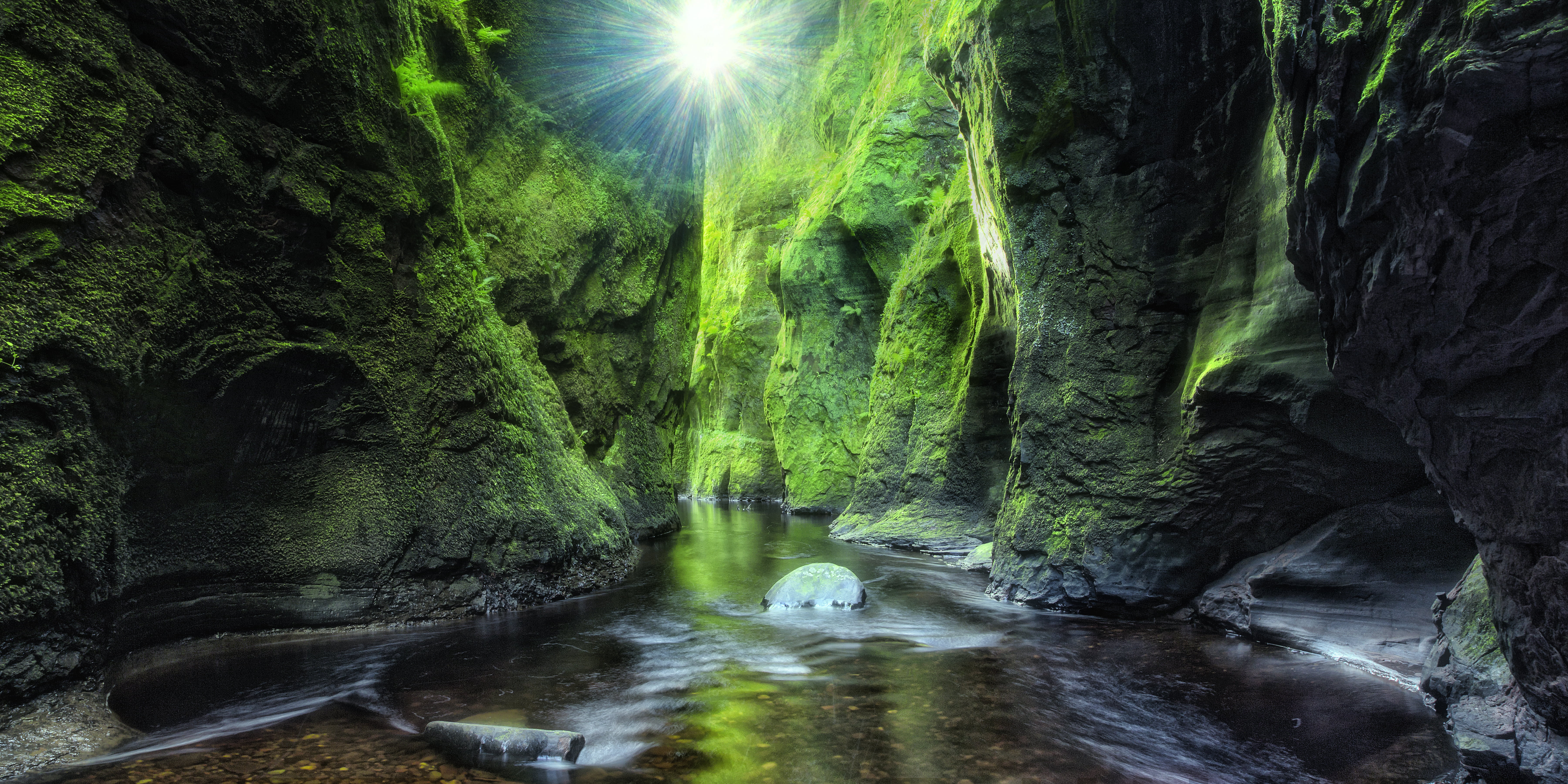body of water in between rocky mountain during daytime Lost 2k 4k 5k